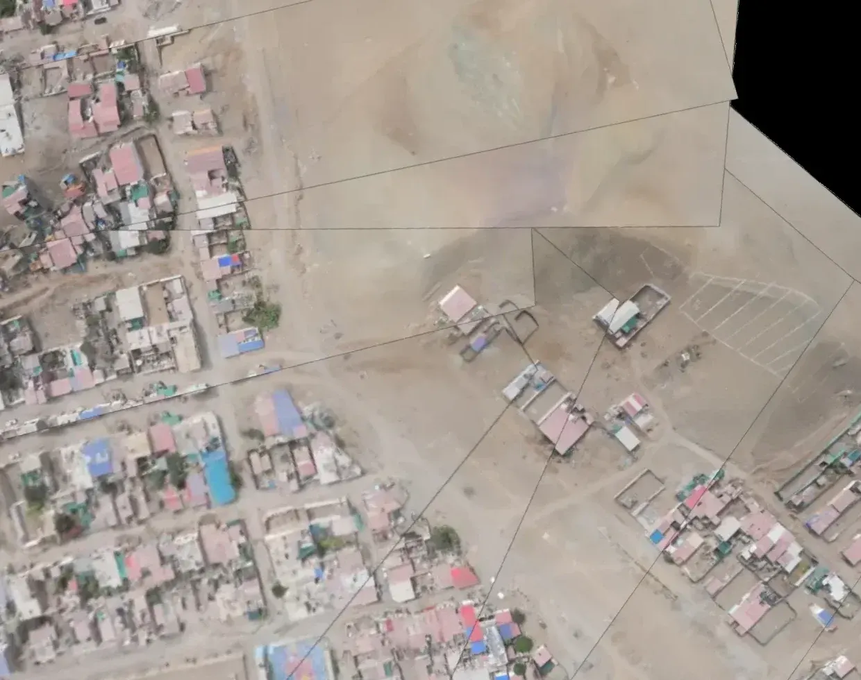 Urban area seen from the air in the first campaign, with open ground at the edge of the settlement
